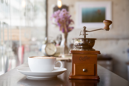 Hot coffee placing together with coffee-mill by selective focus shotingの写真素材