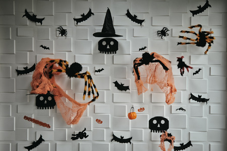Many items of Halloween decorated on white block background; dark tone wallpaper with items such as skull, spider, bat, pumpkin, witch hat and skullの写真素材