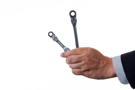 Mechanic engineer holding two ratchet box end wrench in his hand; handing tool on white background...