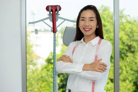 Portrait Of  Confident entrepreneur, Happy Asian Woman Working as Fashion tailorの写真素材