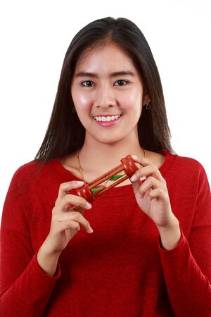 Portrait of young Asian woman holding sandglass and looking at camera with smiling on white...