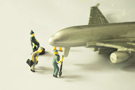 mini toy doll mechanic team check for maintenance airplane. aircraft service concept