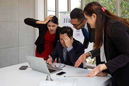 Manager and business team check information in laptop comparing with stress feeling emotion. working with partner and engineering tools in meeting roomの写真素材