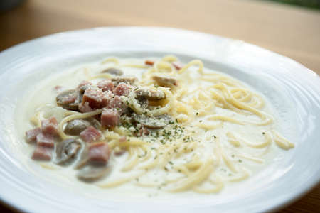 Spaghetti Carbonara with ham mushroom Cream Sauce Italian food selective focus close up in white dishの写真素材
