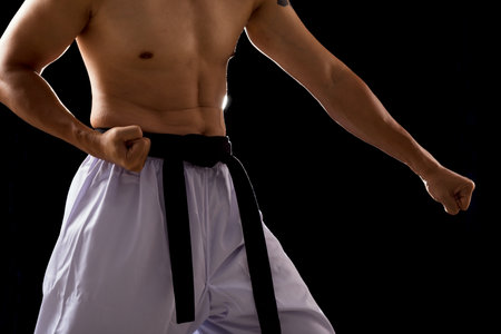 Black Red Belt TaeKwonDo Karate male athlete man show traditional Fighting poses punch on black backgroundの写真素材