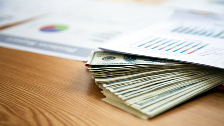 Financial Corruption: Still Life of Dollar Bank Notes under sale graph paper Representing Dishonesty...