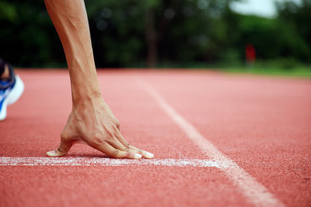 Runner's Hand Close-Up Athletic Preparation on Track; Get Ready to Run Sports and Fitness Lifestyle