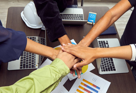 Team work concept; close up of joining hands of businessman in unity hand processing background;...