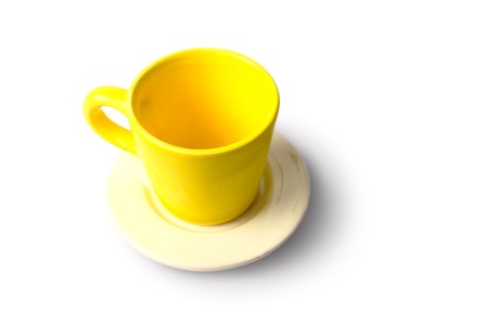 An empty yellow cup with plate の写真素材