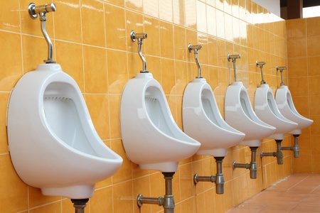 white porcelain urinals in public toiletsの写真素材