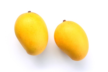 Ripe golden mangoes on white backgroundの写真素材