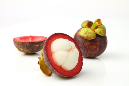 Mangosteen, the queen of tropical fruit over whiteの写真素材