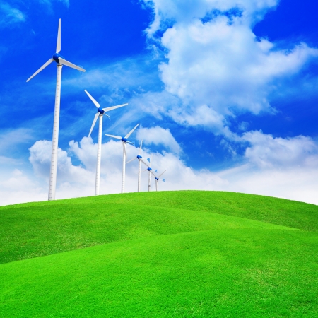 Green meadow with wind turbines generating electricityの写真素材