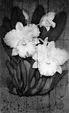 Low relief cement Thai style handcraft of orchid  on wall.のeditorial素材