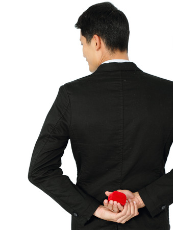 Man making proposal with wedding ring and red gift box.の写真素材
