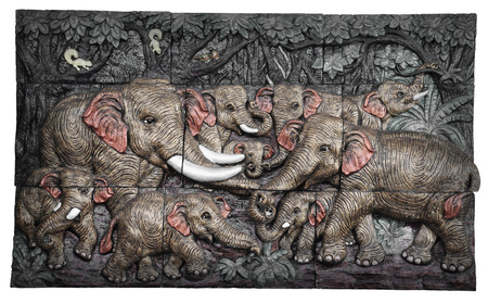 Low relief cement Thai style handcraft of elephant on wall.