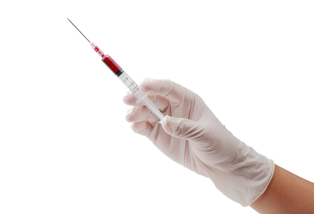 Hand in white disposable gloves holding disposable syringe loaded for injection isolated on white background, clipping path.の写真素材