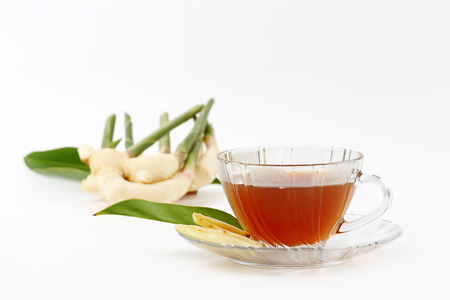 An image slice of fresh ginger root and tea isolated over white background.の写真素材