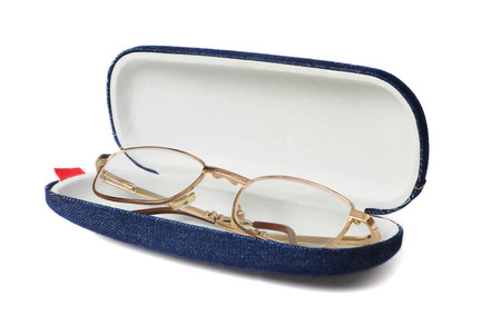 Gold glasses in blue opened fabric case isolated on white background.の写真素材