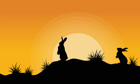 Silhouette of bunny on the hill at sunsetのイラスト素材
