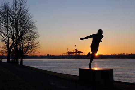 statue of running and downtown vancouverの写真素材