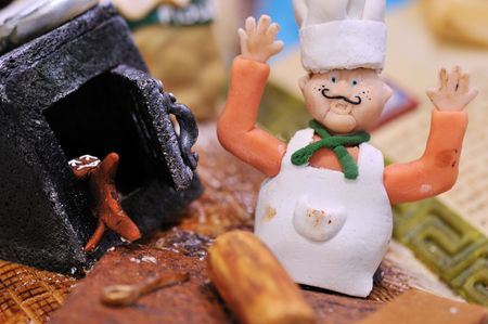 gingerbread chef making cooking in kitchenの写真素材