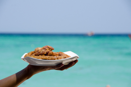 Fried banana in plate with woman hand ,seasideの写真素材