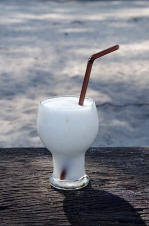Coconut milk  smoothie on wooden table.  Lipe island,Thailandの写真素材