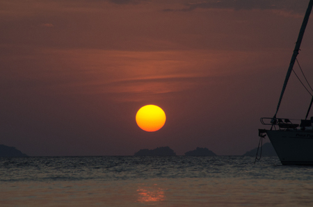 Silhouette sailing boat on the sea at sunset in Adang-Ravi Islandsin,Tarutao National Park, Satun Thailand.の写真素材
