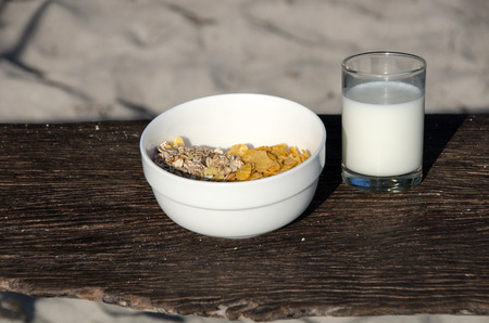 Conflex crispy and fresh milk on old wooden, healthy breakfast.