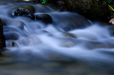 Waterfall with stone of green moss in rain forest , Kiriwong Village, kamloan, Lansaka, Nakhon Si...