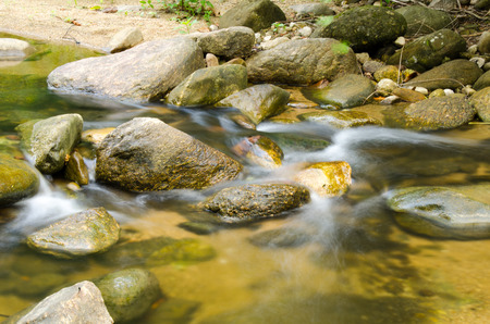 Waterfall with stone of green moss in rain forest , Kiriwong Village, kamloan, Lansaka, Nakhon Si...