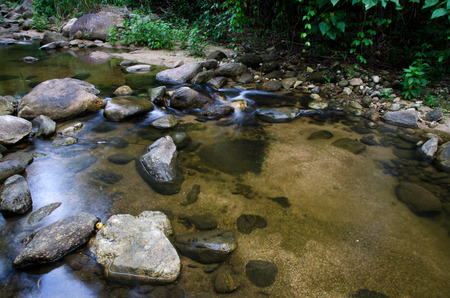 Waterfall with stone of green moss in rain forest , Kiriwong Village, kamloan, Lansaka, Nakhon Si...