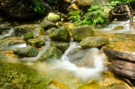 Nice small waterfall cascade on mountain river. Rain forest. Thailandの写真素材