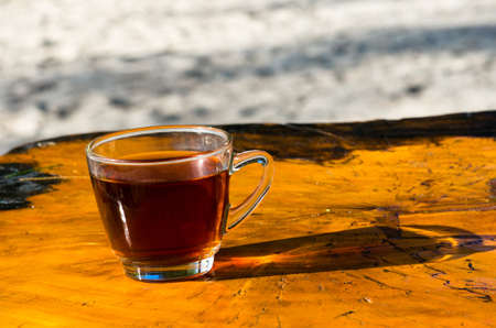 A Cup of freshly brewed black tea,escaping steam,warm soft light, darker background.の写真素材