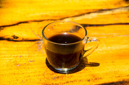 Black coffee on the beachside table with seascape background, nature light. Thailandの写真素材