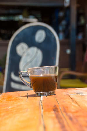 Black coffee on the beachside table with seascape background, nature light. Thailandの写真素材