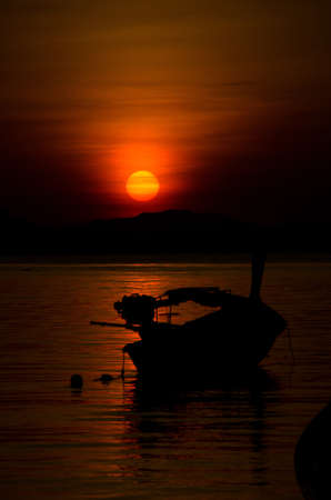 Silhouette longtail boat on the seaÂ at sunriseÂ in Adang-Ravi Islandsin,Tarutao National Park, Satun Thailand.の写真素材