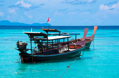 Anchored longtail boats on the coast of the Andaman Sea, Lpie, Satun, Thailand.