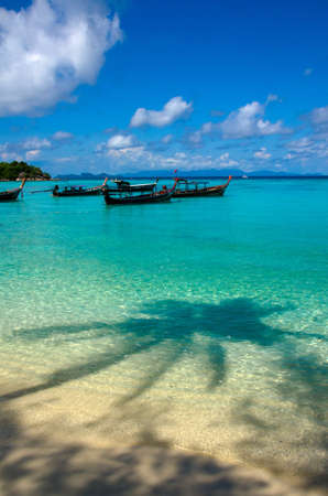 Anchored longtail boats on the coast of the Andaman Sea, Lpie, Satun, Thailand.の写真素材