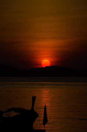 Silhouette longtail boats on the seaÂ at sunriseÂ in Adang-Ravi Islandsin,Tarutao National Park, Satun Thailand.の写真素材