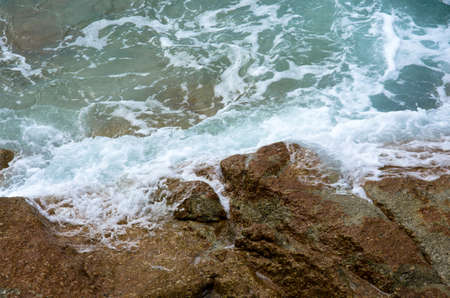 Water splashing. Crystal clear sea water beating against the rocks and cliffs. Waves and sea foam.の写真素材