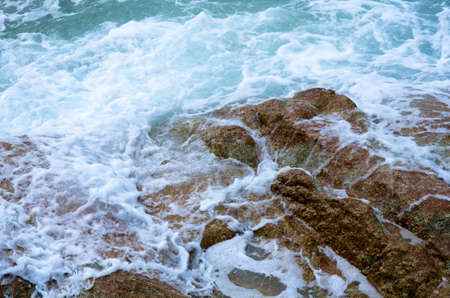 Water splashing. Crystal clear sea water beating against the rocks and cliffs. Waves and sea foam.の写真素材