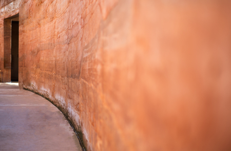 Brown clay blur wall beside of walkwayの写真素材