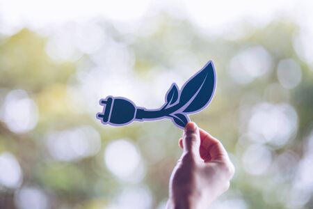 Save world ecology concept environmental conservation with hands holding cut out paper power plug showingの写真素材