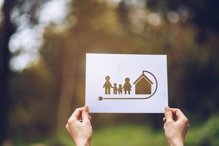 Save world ecology concept environmental conservation with hands holding cut out paper earth loving ecology family showingの写真素材