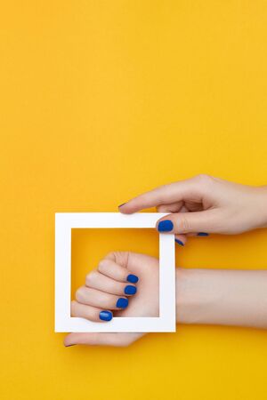 Composition of women's hands with nails in classic blue colorの写真素材