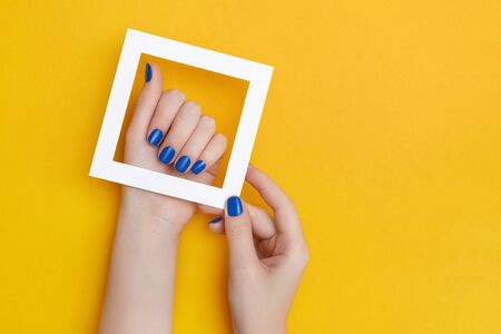 Composition of women's hands with nails in classic blue colorの写真素材