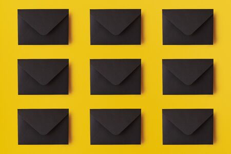 Many black envelopes on the yellow background