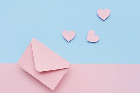 Pink hearts and the pink envelope on the pink and blue double colored background